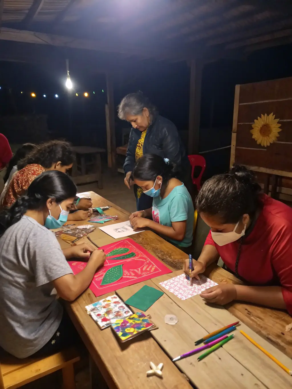 A photo of a workshop where community members are learning traditional crafts, demonstrating Les Amis de la Vineria's commitment to skills development and cultural transmission.
